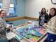 Nursing tech Kristin King and nurses Mona Schlawinsky and Lakyn Blanton take a few minutes to help bring the narwhals to life.