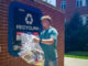 Henry Walke, an environmental and sustainability studies and economics junior, brings recyclable materials from his residence hall to a recycling compactor.