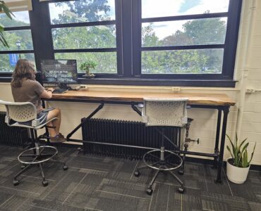 Student works on computer at countertop in an office