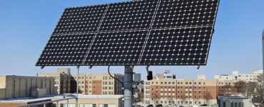 Solar array on UK rooftop with UK dorms in the background