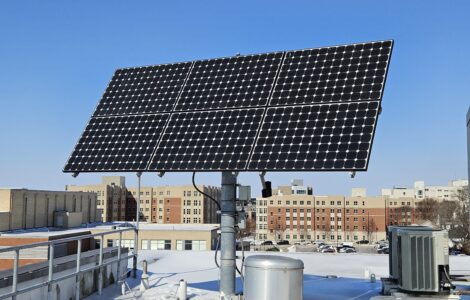 Solar array on UK rooftop with UK dorms in the background