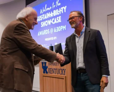 Award recipient and namesake Yanarella shakes hands with Director of Sustainability