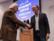 Award recipient and namesake Yanarella shakes hands with Director of Sustainability